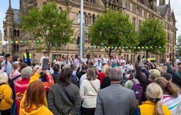A large crowd watch the Fiyalka Ukranian women's voice choir perform in front of Bradford town hall.